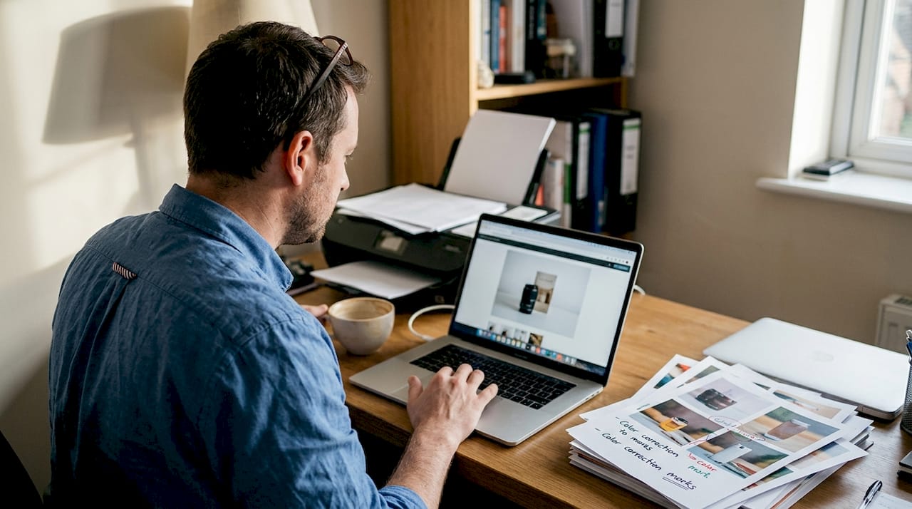 Man editing product photos in home office